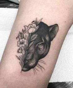 a black and white photo of a dog's head with flowers on its side