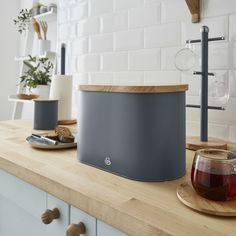 a kitchen counter with a teapot and some cups on it