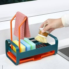 a person holding a brush and sponge in a holder