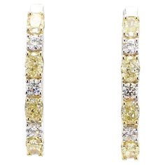 RareGemWorld's classic diamond earrings. Mounted in a beautiful 18K Yellow and White Gold setting with natural oval cut yellow diamonds. The yellow diamonds are surrounded by round natural white diamond melee. These earrings are guaranteed to impress and enhance your personal collection! Total Weight: 2.40cts Center Diamond Measurements: 4.2 - 4.3 x 3.0 - 3.3 mm Side Diamond Measurements: 2.7 - 2.8 mm Natural Oval Yellow Diamonds Natural Round White Diamonds 18K Yellow/White Gold All diamonds are guaranteed natural International Shipments: Please note that customers are responsible for all import duties and taxes applicable to the country of shipment Returns: Returns accepted in original format within 14 days of receipt Do not forget to view our entire inventory! Thank you for reviewing ou Classic Diamond Earrings, Yellow Diamond Earring, Yellow Diamonds, White Gold Set, Sapphire Earrings, Antique Earrings, Modern Earrings, Pearl Stud Earrings, Yellow Diamond