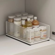 an organized drawer in a kitchen with spices and condiments on the bottom shelf