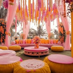 an outdoor wedding setup with pink and orange decor