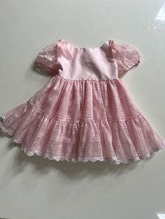 A gorgeous puffy pink pageant dress for toddler girl 4T. Vintage pageant dress with a sheer overlay and puff sleeves in pink. By Faye's Fantasies, tagged 4T, seems accurate. Buttons back of neck. Has belt loops, but lissing belt. I would add pink satin ribbon. Great condition except a little stain on back of neck where button closure is- I have not tried to treat. Measures 19 inches long and 11 inches across pit to pit. Sweet Pink Puff Sleeve Dress, Sweet Pink Dress With Puff Sleeves, Sweet Pink Dresses With Puff Sleeves, Pink Tiered Princess Dress For Spring, Tiered Pink Princess Dress For Spring, Pink Puff Sleeve Tulle Dress, Cute Princess Dress With Puff Sleeves And Ruffles, Fitted Pink Twirl Dress For Dress-up, Pink Fitted Twirl Dress For Dress-up