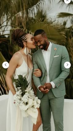 a bride and groom kissing in front of palm trees