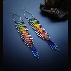 The Extra Long Bead Fringe Shoulder Length colorful Earrings for Women are a bold and eye-catching accessory that exudes vibrancy and playfulness. These earrings are designed to make a statement with their extra-long length and a delightful cascade of colorful bead fringes. Length: 7.25 inches The earrings feature an array of vibrant and vivid colors, carefully chosen to create a visually stunning composition. From bright reds to sunny yellows, lush greens to deep blues, and everything in betwee Unique Rainbow Earrings, Multicolor Vibrant Jewelry With Ear Wire, Vibrant Rainbow Dangle Earrings, Vibrant Multicolor Jewelry With Ear Wire, Vibrant Multicolor Earrings, Multicolor Long Drop Earrings With Colorful Beads, Multicolor Teardrop Jewelry With Colorful Beads, Teardrop Multicolor Jewelry For Festivals, Multicolor Teardrop Jewelry For Festivals