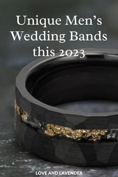 an unique men's wedding band with gold and black inlays on it