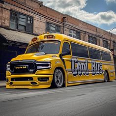 a yellow school bus parked in front of a brick building on the side of the road