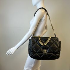 Chanel Maxi 19 Flap Bag with Bi-colored Chain Link Shoulder Strap, Interlocking CC Logo and Quilted Pattern (includes Dustbag) Designer = Chanel Color = Black Material = Lamb Skin Condition = Excellent Height = 10 Width = 14 Depth = 4.5" Class = Premier Location: Wilmette Item Number: 20201-73 Item ID: 300893 Category: Shoulder Bag Designer Tote Shoulder Bag With Cc Turnlock Closure, Evening Tote Shoulder Bag With Cc Turnlock Closure, Everyday Luxury Rectangular Bag With Chain, Luxury Everyday Rectangular Bag With Chain, Rectangular Everyday Luxury Bag With Chain, Luxury Chain Crossbody Bag, Rectangular Chain Bag For Everyday Luxury, Luxury Shoulder Bag With Chain In Crossbody Style, Designer Shoulder Bag With Chain Detail