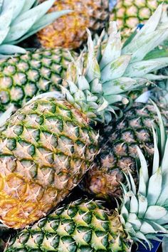 several pineapples are stacked on top of each other