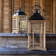 two wooden lanterns sitting on top of a table