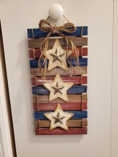 a wooden wall hanging with three stars on it