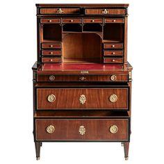 an antique wooden desk with drawers and doors on the bottom shelf, one drawer open