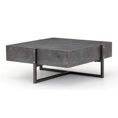 a square concrete coffee table with metal legs