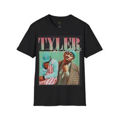 Show your admiration for one of the most innovative artists in modern music with this retro Tyler, The Creator Graphic T-Shirt. Featuring a bold and vibrant design of Tyler in his signature style, this shirt is a must-have for any fan. Made from soft, premium cotton, it offers comfort without compromising on style. Perfect for everyday wear, concerts, or as a standout piece in your streetwear collection, this T-shirt celebrates Tyler, The Creator's unique influence on music and fashion. Whether Pop Culture Graphic Print T-shirt For Concert, Hip Hop Graphic T-shirt For Concerts, Graphic Print Tops For Music Festivals Streetwear, Music Festival Graphic Crew Neck Tops, Sublimation Print Tops For Streetwear At Music Festivals, Graphic Design Crew Neck Top For Music Festivals, Graphic Crew Neck Top For Music Festivals, Trendy Graphic Design Tops For Fan Merchandise, Trendy Concert T-shirt With Sublimation Print