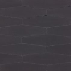 a black tile wall with hexagonal shapes