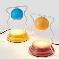 three different colored lamps sitting next to each other