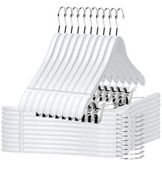 a stack of white hangers with black pins