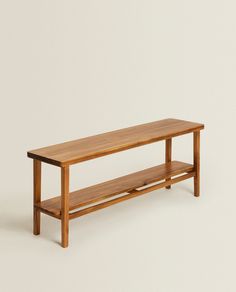 a wooden bench sitting on top of a white floor