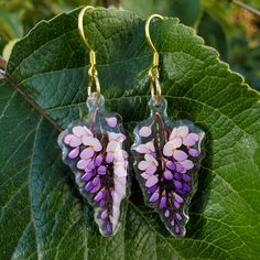 🎉 Special Introductory Offer: FREE SHIPPING for a Limited Time! 🎉 Add a touch of nature's charm and symbolic meaning to your ensemble with these beautifully designed wisteria earrings - now with free shipping! 🌺 The Symbolism of Wisteria In Eastern traditions, wisteria represents longevity, endurance, and even immortality. In the Western world, it is associated with romance, poetry, and nostalgia, embodying the beauty of love and transformation. 🌺 Product Highlights: Meaningful Design: Each earring features a delicately detailed wisteria, capturing both natural beauty and symbolic significance. Premium Materials: Crafted from durable, lightweight acrylic with gold plated sterling silver findings for a finishing touch. Versatile Style: Perfect for daily wear, special occasions, or as a Wisteria Earrings, Romance Poetry, Meaningful Design, Symbolic Jewelry, Western World, Purple Flower, Wisteria, Gold Plated Sterling Silver, Earrings Gold