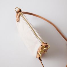 The Natural Canvas Medium Crossbody Bag is a canvas and leather bag handmade in the KMM & Co. studio in Atlanta. Each one is meticulously crafted from heavyweight canvas, full-grain leather, a solid brass zipper, and solid brass D-rings to attach a crossbody strap. (Choose from one made in the same leather as the gusset of the bag — a vintage-inspired chain link strap, a super-adjustable slider strap, or a squishy two-ply strap — or go with a classic crossbody strap in Russet or in your choice o Everyday Crossbody Belt Bag With Leather Handles, Beige Shoulder Bag With Brass Hardware For Everyday Use, Everyday Leather Handles Belt Bag Crossbody, Everyday Leather Canvas Bag With Zipper Pocket, Daily Use Canvas Shoulder Bag With Brass Hardware, Leather Canvas Bag With Zipper Pocket For Everyday, Leather Bag Handmade, Medium Crossbody Bag, Classic Leather Tote