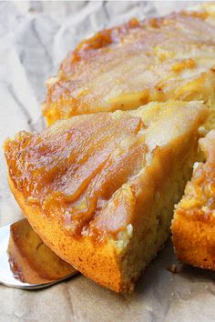 a close up of a cake on a table with a spoon next to it and one slice missing