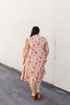 Introducing the Lindley Midi, a luxurious cream shirt dress adorned with delicate pink florals. This midi dress features a button-up design, 3/4 sleeves, and convenient pockets. Make a statement in this elegant and exclusive piece. Fits true to size. Model is wearing a small and is 5'5". Plus model is wearing a 1X and is 5'7". Size Chart Length Bust Waist S 41" 35" 35" M 42" 38" 38" L 42" 40" 40" XL 43.5" 42" 42" 1x 44" 46" 46" 2x 44" 48" 48" 3x 44" 52" 52" *Measurements are approximate and are Feminine Midi Shirt Dress For Brunch, Spring Cream Midi Dress With Floral Print, Pink Midi Length Shirt Dress For Daywear, Feminine Shirt Dress For Day Out, Midi Length, Collared Floral Print Midi Dress For Day, Floral Print Midi Dress With 3/4 Sleeves For Daywear, Spring Mid-length Shirt Dress For Day Out, 3/4 Sleeve Floral Midi Dress For Daywear, Pink Floral Print Dress With 3/4 Sleeves