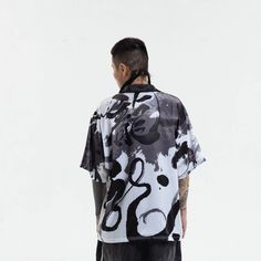 Experience the perfect fusion of street style and casual comfort with our Dragon Calligraphy Cuban Half Shirt. This shirt features an all-over print of calligraphy artwork, exuding a unique and edgy street vibe. The addition of ink splatter prints adds depth and character to the design. A single pocket adorns the left chest, offering both style and functionality. With half sleeves and a Cuban collar, this shirt strikes the perfect balance between modern and retro aesthetics. Crafted from premium Hip Hop Tops With Graffiti Print For Spring, Hip Hop Style Graffiti Print Tops For Spring, Graffiti Print Short Sleeve Tops For Streetwear, Spring Hip Hop Graffiti Print Tops, Short Sleeve Tops With Graffiti Print For Streetwear, Casual Graffiti Print Streetwear Shirt, Casual Graffiti Print Shirt For Streetwear, Casual T-shirt With Abstract Print, Streetwear Graphic Print Shirt For Spring