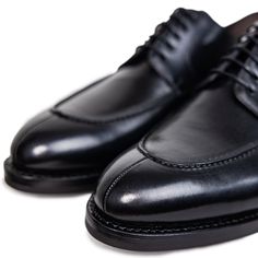 Ready to conquer the day? We’ve taken our timeless split toe derby silhouette and made it deep, dark, and black. This is a traditional, rich and refined shoe has an edge over the classic cap toe oxfords. We’ve also made this dress shoe with a Dainite sole so you can wear them all year round. Whether it's a formal events, or a night out with friends this is the perfect allrounder. Upper: Full-grain Italian leather Sole: Dainite lugged sole, British made* Construction: 360° Storm Goodyear welt (Re Business Lace-up Cap Toe Shoes With Goodyear Welting, Timeless Goodyear Welted Lace-up Shoes With Round Toe, Formal Lace-up Shoes With Goodyear Welted Cap Toe, Formal Lace-up Shoes With Goodyear Welt And Cap Toe, Timeless Plain Toe Oxford For Derby, Timeless Plain Toe Oxford For Formal Occasions, Timeless Plain Toe Oxford Shoes For Derby, Classic Plain Toe Lace-up Shoes, Classic Fitted Plain Toe Lace-up Shoes