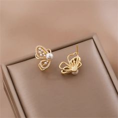 Description:Chic Butterfly Pearl Earrings Specifications:Size: 1.9 cm * 1.1 cmWeight: 3 g/pairMaterial: Copper, Cubic Zirconia, Pearl, S925 silver, GoldColors: Gold Butterflies and pearls? Don't mind if we do! These Chic Butterfly Pearl Earrings add a playful touch to any outfit. With their unique design and delicate pearls, they'll have you fluttering with style. Now that's what we call a fashion statement! 🦋💎 Elegant Pierced Butterfly Jewelry, Elegant Butterfly Earrings For Formal Occasions, Elegant Butterfly Charm Earrings, Elegant Silver Earrings With Butterfly Charm, Elegant White Earrings With Butterfly Charm, Elegant White Butterfly Charm Earrings, Elegant Gold Butterfly Earrings, Elegant Gold Butterfly-shaped Earrings, Elegant Gold Earrings With Butterfly Charm