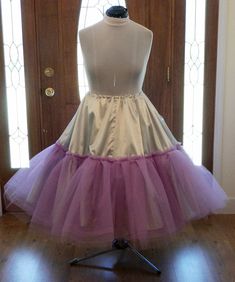 This crinoline petticoat is made to match your wedding dress colors or your wedding colors. The pictures shown are for a silver and lavender fall wedding. I can make this crinoline in most any color combination that is available in fabrics. This crinoline is best suited for 1950s 50s swing dresses that are very voluminous and very full. Makes a gorgeous accessory to your reception dancing 50s swing dresses brides . The crinoline base fabric is bridal satin. The tulle is a very stiff crinoline tu Costume Party Full Tulle Petticoat, Vintage Full Skirt Petticoat For Costume, Full Tulle Petticoat For Costume Party, Spring Can-can Petticoat In Crinoline, Tulle Petticoat With Attached Cancan, Fitted Gathered Petticoat For Costume Party, Vintage Ruffled Petticoat For Costume, Fitted Petticoat With Gathered Skirt For Costume Party, Can-can Crinoline Petticoat With Tiered Skirt