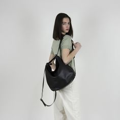 "Black convertible leather bag from soft Italian leather : Converts from backpack to shoulder bag and crossbody bag with the single use of one strap. The main style of the bag is a soft and slouchy hobo bag. The permanent long strap on the bag can be easily adjusted to your desired length in order to wear the bag on your shoulder, as a crossbody bag or as a backpack. **Important point is that when you adjust the strap to a backpack the strap is stable and does not slide from one side to the othe Slouchy Hobo Bag, Black Convertible, Leather Laptop Backpack, Hobo Crossbody Bag, Black Crossbody Purse, Convertible Backpack, Black Leather Backpack, Black Leather Handbags, Leather Bag Women