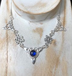 "I've fabricated a Victorian Bohemian style necklace with a center Celtic knot which features a center 10mm natural cabochon gemstone of your choosing, with two Trinity component pieces on either side, and two Celtic stenciling components to compliment the trinity knots. The sterling chain of 15 inches is soldered to each end making the approximate length of this piece just a bit over 18\" total. The chain will have a sturdy lobster claw. If you prefer a faceted gemstone, within a heavy 4 prong Artisan Birthstone Pendant Necklace, Artisan Birthstone Necklace For Gifts, Spiritual Necklaces With Round Natural Stones, Spiritual Sterling Silver Necklace With Round Stone, Spiritual Nickel-free Moonstone Necklaces, Spiritual Moonstone Nickel-free Necklace, Nickel-free Moonstone Spiritual Necklace, Silver Bohemian Birthstone Necklace, Spiritual Cabochon Necklaces