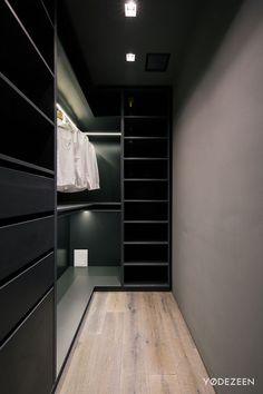 an empty walk in closet with black shelves