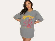 Fun and funky retro style football tee, perfect for tailgating and cheering on your favorite team! Features 70s style characters for a cute and fun look. SIZE AND FIT  These Comfort Colors® shirts are soft, high-quality, unisex t-shirts with a unique vintage, worn-in aesthetic. These shirts are true to size, so if you prefer an oversized look - size up. For a more fitted look - size down. If you are going for the 'shirt dress' look, I recommend going up two sizes. Please refer to the size chart in the photos for exact dimensions.   MATERIAL & FEATURES  - 100% ringspun cotton  - Preshrunk, soft-washed, garment dyed fabric  - Twill taped shoulder-to-shoulder  - Set-in sleeves  - Double-needle stitched sleeves and bottom hem  - 1" ribbed collar with double topstitched neckline   CARE  - Wash School Spirit Graphic Print Top For Fan Gear, Graphic Tee For Game Day With Short Sleeves, Short Sleeve Graphic Tee For Game Day, Graphic Tee Tops For Game Day With Short Sleeves, Football Season Screen Print Tops For College, Screen Print Tops For College Football Season, Screen Print Tops For Football Season, Football Season Graphic Tee Fan Gear, Football Season Fan Gear Graphic Tee