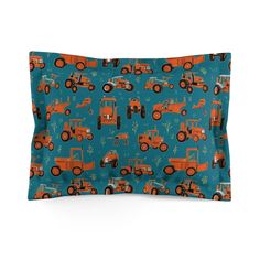 a blue pillow with orange tractors on it