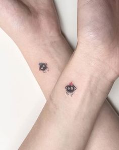 two small tattoos on both wrist and arm, each with an insect in the middle