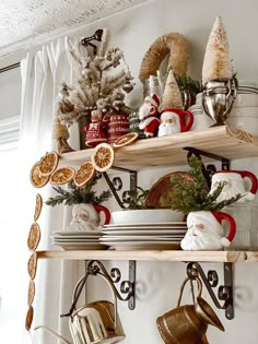 a shelf with christmas decorations on it and other items hanging from the shelves above them