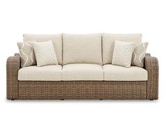 a wicker couch with four pillows on it's back and two sides, in front of a white background