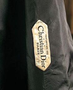 a black jacket with a gold label on the front and back side that says, christland's way