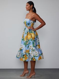 Effortlessly chic and versatile, this strapless midi dress features a beautiful floral print and a flattering tiered skirt. Completing the look is the included belt for a figure-flattering silhouette. Strapless Floral Print Sundress For Garden Party, Summer Floral Print Strapless Midi Dress, Strapless Ruffled Sundress For Garden Party, Strapless Floral Sundress For Garden Party, Strapless Floral Print Dress For Spring, Spring Strapless Floral Dress, Strapless Floral Dress For Spring, Strapless Ruffled Midi Dress For Garden Party, Chic Floral Print Strapless Dress For Brunch