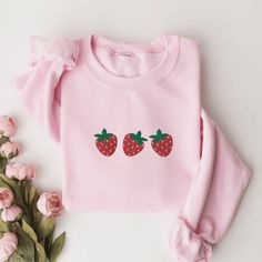 Strawberry Sweatshirt, Embroidered Strawberry Crewneck Sweatshirt, Strawberries Shirt, Cute Embroidered Sweatshirt, Berry Embroidered Shirt This embroidered strawberry crewneck sweatshirt is everything. Perfect to show your love for strawberries! Please let me know if you would like extended sizing (3X-5X), I have certain color and size options available! ✨ 50% cotton, 50% polyester ✨ Pre-shrunk ✨ Classic fit Care: Machine wash: warm (max 40C or 105F) Tumble dry: low Cute Long Sleeve Embroidered T-shirt, Casual Pink Sweatshirt With Machine Embroidery, Sweet Long Sleeve Cotton Sweatshirt, Long Sleeve Cotton Tops With Strawberry Print, Casual Long Sleeve Tops With Strawberry Print, Casual Pink Sweatshirt With Floral Embroidery, Strawberry Sweatshirt, Strawberry Clothes, Embroidered Strawberry