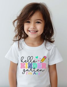 Hello School Shirt, Hello Kindergarten Shirt, Personalized Kids Name Shirt, Custom Grade Shirt, Pre-K School Shirt, Back To School Shirt Welcome to TeeDesignUS! We have selected the most special products for you and are at your service. We are here for everything you need. We wish you pleasant shopping! PRODUCT DETAILS We use Bella Canvas and Gildan SoftStyle brand shirts for printing. *Bella Canvas -unisex size -4.2 oz. -Solid colors are 100% Combed Cotton and Ring-Spinned Cotton. -Athletic Hea Cute Crew Neck Shirt For End Of School Year, Cute Cotton Tops With Name Print, Cute School Tops With Name Print, Cute Crew Neck Shirt With Name Print, Cute School Shirt With Name Print, Cute Crew Neck Tops For End Of School Year, Cute Text Print Tops For School, Cute T-shirt With Name Print For Teacher Appreciation, Cute Tops With Name Print For Teacher Appreciation