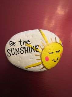 a painted rock with the words be the sunshine on it