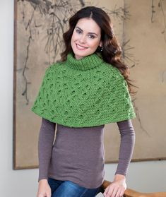 a woman wearing a green knitted shawl