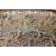 an upholstered couch with intricate designs on it