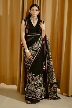 Black saree with aari thread embroidered floral motifs and scalloped border. Comes with padded scalloped border blouse. - Aza Fashions Designer V-neck Choli With Resham Embroidery, Festive Black V-neck Sets, V-neck Saree For Reception And Festivals, Festive V-neck Saree With Dupatta, Diwali V-neck Lehenga With Resham Embroidery, Bollywood Style V-neck Blouse With Dupatta, Embroidered V-neck Saree For Festivals, Georgette V-neck Blouse With Zari Work, V-neck Dupatta With Pallu For Eid