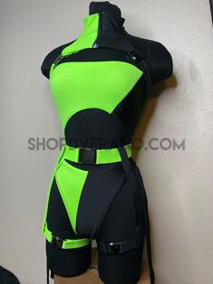 a mannequin wearing a green and black bodysuit with straps on it's chest