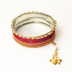 A specially curated Chalni for the auspicious celebration of Karwa Chauth, this Chalni is handmade with pure rawsilk fabric with golden & pearl colored beads that look absolutely elegant. Standard Chalni - 6.5 inches in diameter Gift this Pooja thali along with chalni for your wife who would be keeping a fast for you on the festive occasion of Karwa Chauth Silk Bangles, Pooja Thali, Raw Silk Fabric, Potli Bags, Peacock Green, Indian Festivals, Gold Lace, Bottle Green, Pearl Color