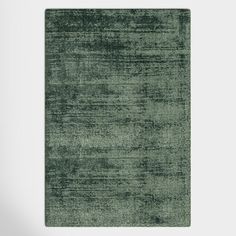 a green area rug on a white wall