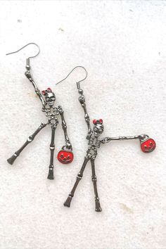 Elegant red bag lady skeleton earrings. Creepy but sweet, scarry but cute, frightening but happy... These earrings make you smile and add C-class horror movie look to your outfit. Check it and test how addictive skeletons earrings might be #skullmakeup #skullart #skullhead #skulljewelry #skullearrings #skulladdict #skulladdiction #earringsforsale #etsyearrings #halloweencostume #halloweenjewelry #halloweenearrings Spooky Red Halloween Jewelry, Red Novelty Jewelry For Halloween, Cute Halloween Party Jewelry, Red Metal Halloween Earrings, Red Earrings As Halloween Gift, Red Earrings For Halloween Gift, Fun Red Jewelry For Halloween, Red Fun Halloween Jewelry, Fun Red Halloween Jewelry